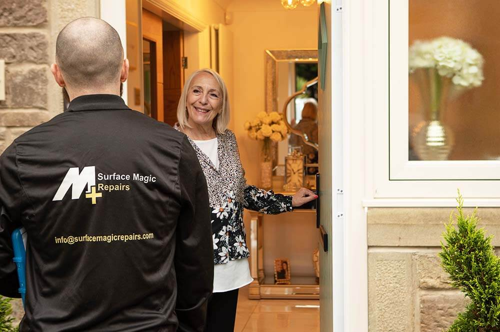 Surface Magic Repairs specialist greeting a happy customer at her front door.